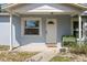Charming entrance with a decorative front door, welcome mat, and planting stand at 12660 118Th St, Largo, FL 33778