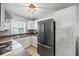 Modern kitchen with white cabinets and stainless steel refrigerator at 12660 118Th St, Largo, FL 33778