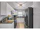 Well-lit kitchen featuring modern appliances, white cabinets, and granite countertops at 12660 118Th St, Largo, FL 33778