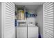 Functional laundry area with a washer and dryer, shelving, and ample storage space at 12660 118Th St, Largo, FL 33778