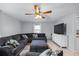 Comfortable living room with a large sectional sofa and a ceiling fan at 12660 118Th St, Largo, FL 33778