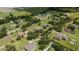 An aerial shot captures a residential area bordered by lush greenery and distant agricultural fields at 13122 Done Groven Dr, Dover, FL 33527