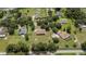 An aerial view of the subdivision with homes, trees, and a pond during daylight hours at 13122 Done Groven Dr, Dover, FL 33527