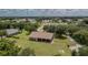 An aerial view shows the home's expansive yard, mature trees, and screened-in back porch at 13122 Done Groven Dr, Dover, FL 33527