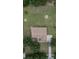 Aerial view of a well-maintained home with a brown roof, a fire pit, and mature landscaping at 13122 Done Groven Dr, Dover, FL 33527
