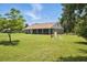 The manicured lawn and partially screened lanai highlight the backyard's tranquil setting at 13122 Done Groven Dr, Dover, FL 33527
