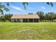 Relaxing in the large backyard, with its covered patio, is an ideal way to enjoy the outdoors at 13122 Done Groven Dr, Dover, FL 33527