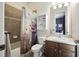 Cozy bathroom featuring a shower-tub combo with a fun shower curtain and a wood vanity at 13122 Done Groven Dr, Dover, FL 33527