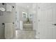 Bright bathroom featuring a soaking tub with stone accents, neutral tile, and a serene, spa-like atmosphere at 13122 Done Groven Dr, Dover, FL 33527