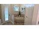 Luxurious bathroom with a tiled whirlpool tub, tiled surround, and natural light at 13122 Done Groven Dr, Dover, FL 33527