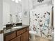 Bathroom featuring granite counters, updated vanity, and a shower-tub combination with a patterned curtain at 13122 Done Groven Dr, Dover, FL 33527