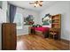 Kid-friendly bedroom with hardwood floors and unique wall decor at 13122 Done Groven Dr, Dover, FL 33527