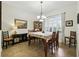 Bright dining room with large window, chandelier, and stylish decor, perfect for Gathering meals and entertaining at 13122 Done Groven Dr, Dover, FL 33527