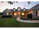 Charming home with a landscaped yard, inviting front porch, and dormer windows, exuding curb appeal at 13122 Done Groven Dr, Dover, FL 33527