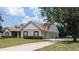 Inviting two-story home with attached garage, manicured lawn, and a long driveway at 13122 Done Groven Dr, Dover, FL 33527