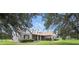 The charming home features a covered front porch, manicured landscaping, and lovely architectural details at 13122 Done Groven Dr, Dover, FL 33527