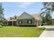 This home features a well-manicured lawn, mature trees, and an attached two-car garage at 13122 Done Groven Dr, Dover, FL 33527