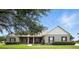 The house features an inviting front porch, well-maintained landscaping, and a neutral color palette at 13122 Done Groven Dr, Dover, FL 33527