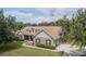 This beautiful home has a manicured lawn, mature trees, and a long driveway, creating great curb appeal at 13122 Done Groven Dr, Dover, FL 33527