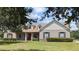 Charming single-story home with well-maintained lawn and landscaped front yard at 13122 Done Groven Dr, Dover, FL 33527