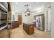 This is a kitchen featuring stainless steel appliances, dark wood cabinetry and an island with ample counter space at 13122 Done Groven Dr, Dover, FL 33527