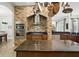 Modern kitchen with brick accent wall, stainless steel appliances, and center island at 13122 Done Groven Dr, Dover, FL 33527