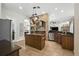 Stylish kitchen featuring a center island, stainless steel appliances, and brick accents at 13122 Done Groven Dr, Dover, FL 33527