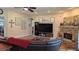 Inviting living room featuring a brick fireplace, wooden floors, and built-in shelving at 13122 Done Groven Dr, Dover, FL 33527