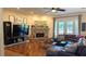 Spacious living room featuring hardwood floors, brick fireplace, and French doors at 13122 Done Groven Dr, Dover, FL 33527