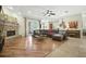 Open-concept living room with brick fireplace, hardwood flooring, and large seating area at 13122 Done Groven Dr, Dover, FL 33527
