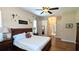 Bright bedroom with hardwood floors, accent decor, and access to the en-suite bathroom at 13122 Done Groven Dr, Dover, FL 33527