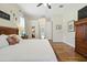 Serene main bedroom with hardwood floors, natural light, and a view to the hallway at 13122 Done Groven Dr, Dover, FL 33527