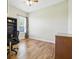 Well-lit home office featuring hardwood floors and a modern desk setup with natural light at 13122 Done Groven Dr, Dover, FL 33527