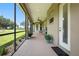 Inviting screened patio offering beautiful outdoor views, ceiling fan, and stylish accents at 13122 Done Groven Dr, Dover, FL 33527