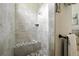 Modern shower with tiled walls, a built-in bench, and sleek fixtures for a luxurious bathing experience at 13122 Done Groven Dr, Dover, FL 33527