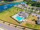 Aerial view of the community pool area with a clubhouse and ample parking at 1314 Oak Pond St, Ruskin, FL 33570