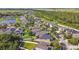 An aerial view of the neighborhood showcasing houses, green spaces, and water features at 1314 Oak Pond St, Ruskin, FL 33570