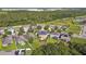 Aerial backyard view with lush green lawn, fenced yard, and a patio area at 1314 Oak Pond St, Ruskin, FL 33570