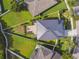 Bird's-eye view of the home highlighting a modern roof, manicured lawn, and patio at 1314 Oak Pond St, Ruskin, FL 33570