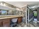 Spacious bathroom with marble floors/walls, vanity with seating, providing a spa-like experience for relaxation at 1314 Oak Pond St, Ruskin, FL 33570