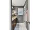 Bathroom featuring white marble floors, a dark vanity, and modern finishes at 1314 Oak Pond St, Ruskin, FL 33570