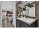 Stylish powder room features a sleek vanity, decorative mirror, and modern lighting fixtures at 1314 Oak Pond St, Ruskin, FL 33570