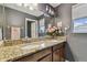 Bathroom features granite countertops and a double sink with flower decorations at 1314 Oak Pond St, Ruskin, FL 33570