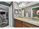 Bathroom with granite countertops, double sinks, and a view into the dining area at 1314 Oak Pond St, Ruskin, FL 33570