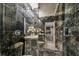 Elegant bathroom with marble tile shower, contemporary fixtures, and a seamless glass door at 1314 Oak Pond St, Ruskin, FL 33570