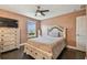 Bedroom with large window, dresser, and hardwood floors at 1314 Oak Pond St, Ruskin, FL 33570