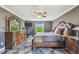 Bedroom with custom furniture, including bed and end tables, as well as TV and mirror at 1314 Oak Pond St, Ruskin, FL 33570