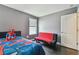 Bedroom with a twin bed and a red futon at 1314 Oak Pond St, Ruskin, FL 33570