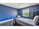 Blue bedroom featuring a twin bed, a window with a view, and a closet at 1314 Oak Pond St, Ruskin, FL 33570