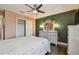 Bright bedroom featuring a dresser, dark wood floors, and modern ceiling fan at 1314 Oak Pond St, Ruskin, FL 33570